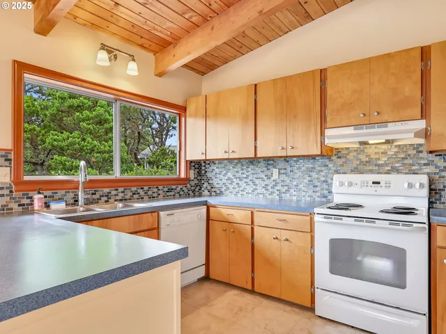 a kitchen with sink and large window