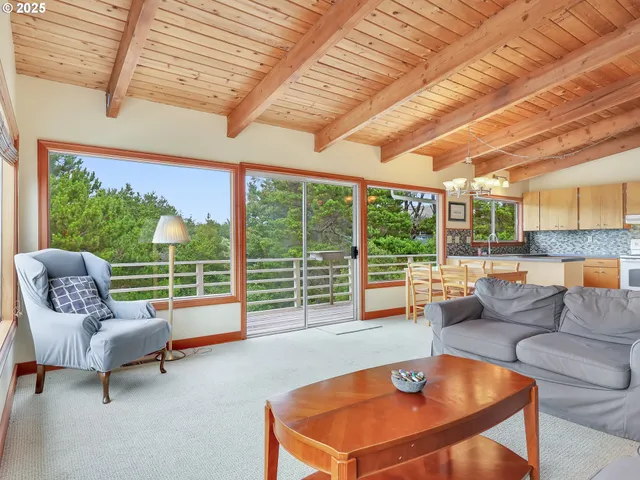 a living room with furniture and large windows