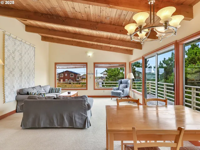 a view of a patio with a table chairs and a backyard