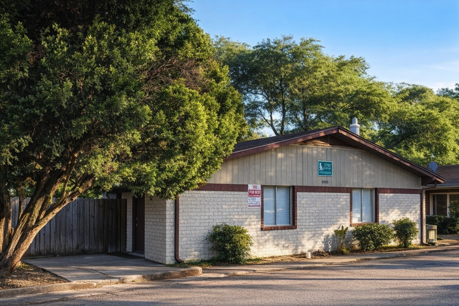 a front view of a house with yard and trees