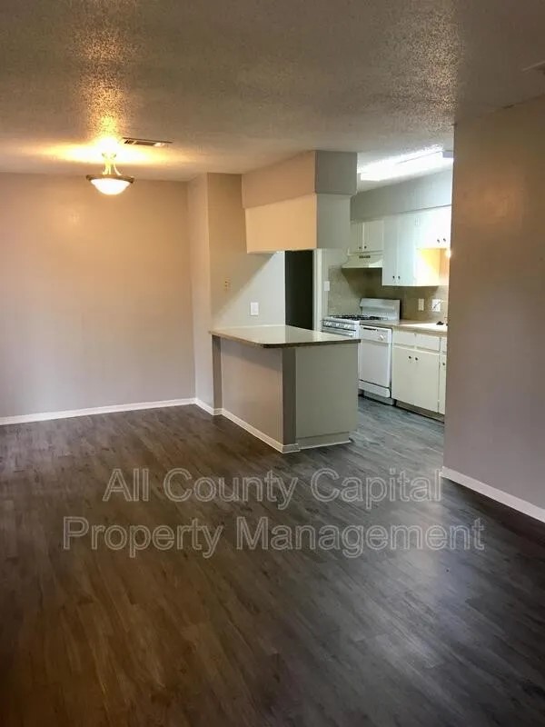 6506 South South First Street, Unit 103 Austin, TX 78745 - Photo 2 of 5 a kitchen with a sink and cabinets