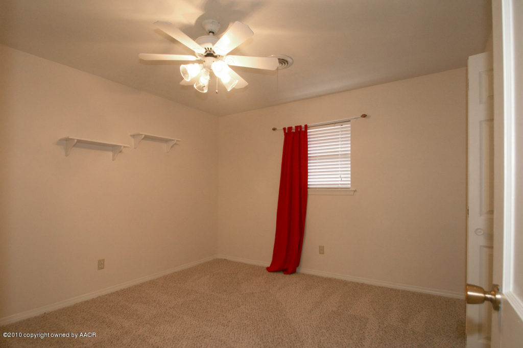 3309 Lombard Road Amarillo, TX 79106 - Photo 3 of 13 a view of a room with a ceiling fan and a window