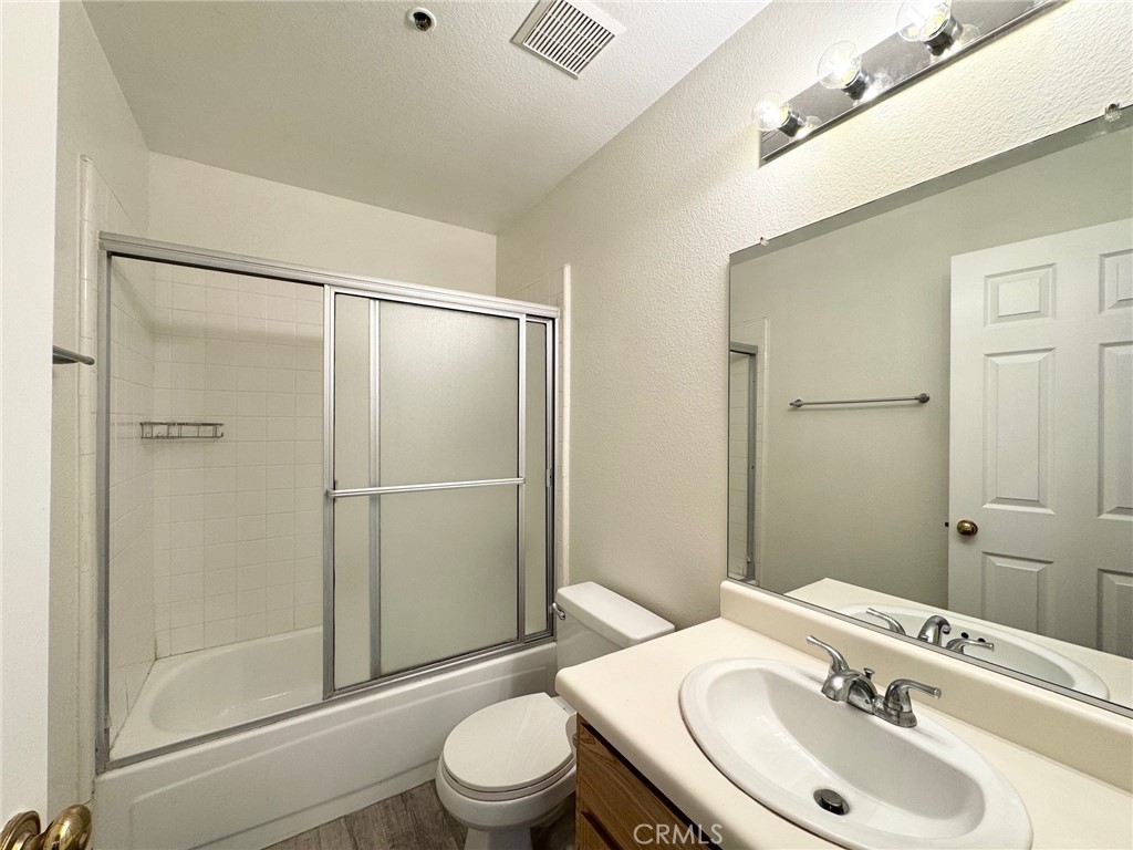17511 Newland Street, Unit D Huntington Beach, CA 92647 - Photo 13 of 15 a bathroom with a sink toilet and shower