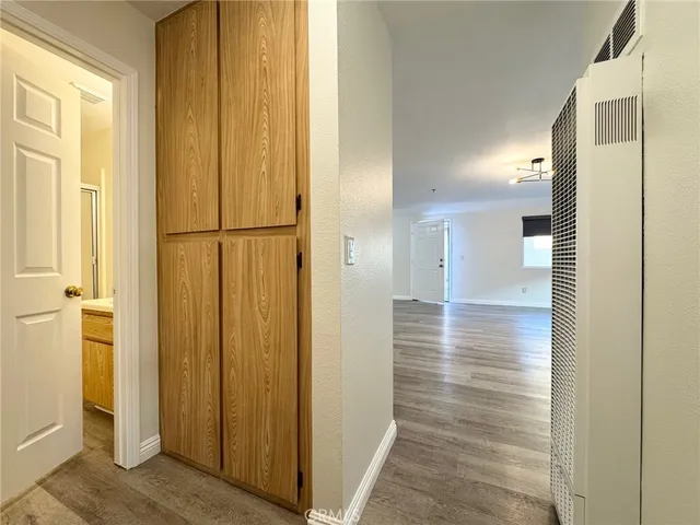 a view of a hallway with wooden floor