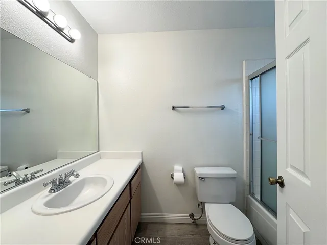 a bathroom with a sink toilet and a mirror