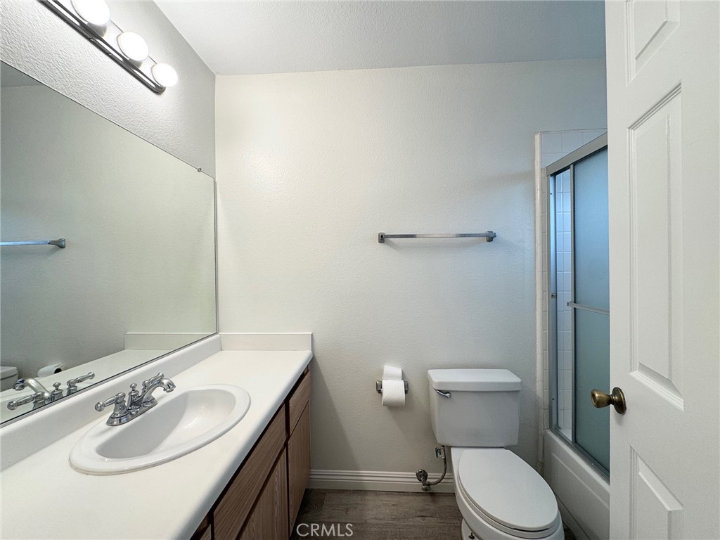17511 Newland Street, Unit D Huntington Beach, CA 92647 - Photo 9 of 15 a bathroom with a sink toilet and a mirror