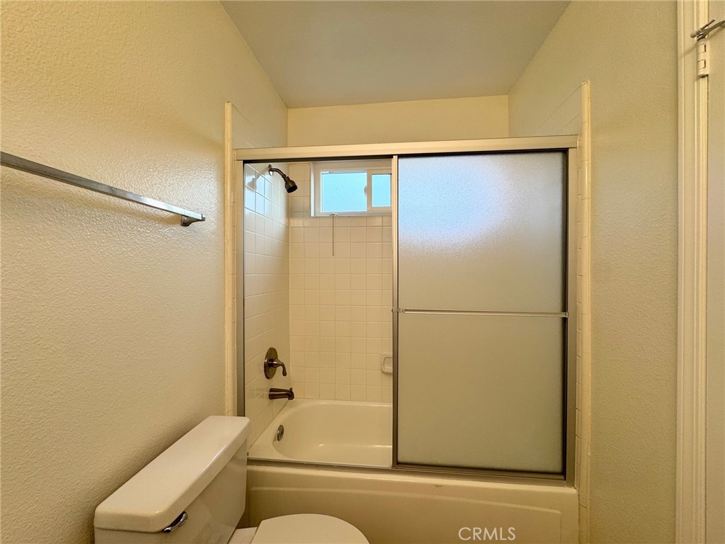 17511 Newland Street, Unit D Huntington Beach, CA 92647 - Photo 10 of 15 a bathroom with a shower and a toilet