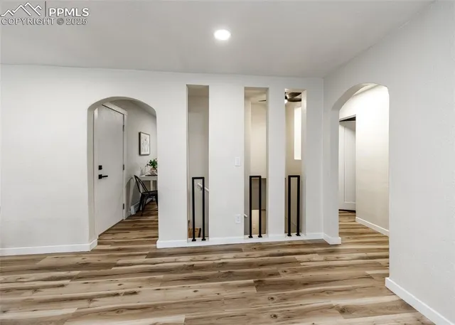 a view of a livingroom with wooden floor and a window
