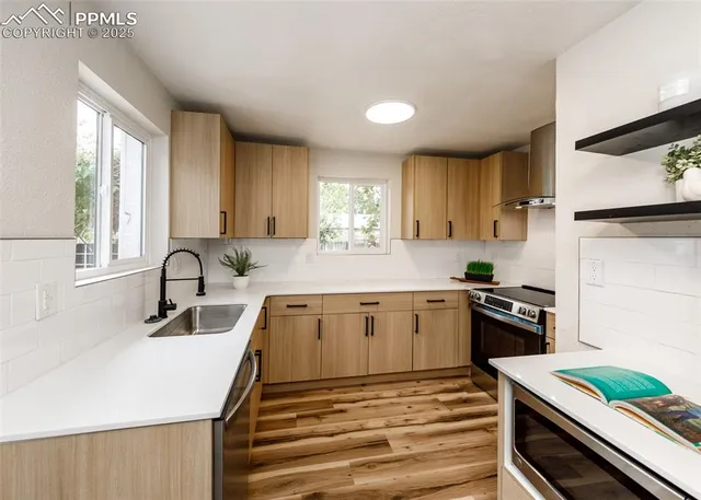 a kitchen with a sink stove top oven and refrigerator