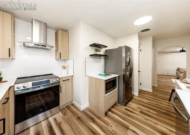 a kitchen with stainless steel appliances a stove a sink and a refrigerator