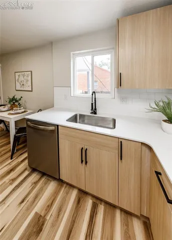 a kitchen with a sink window and cabinets