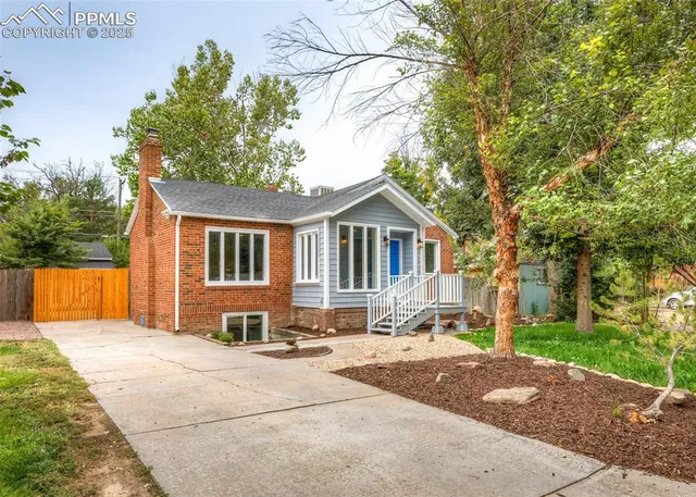 a front view of house with yard outdoor seating and barbeque oven