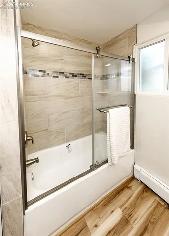 a bathroom with a bathtub and a shower