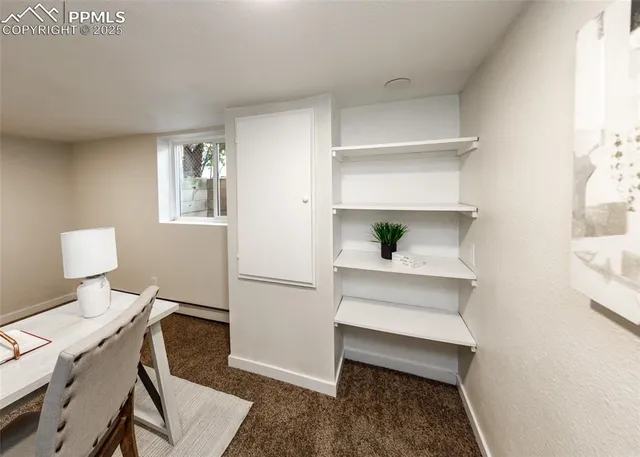 a workspace with furniture and a window