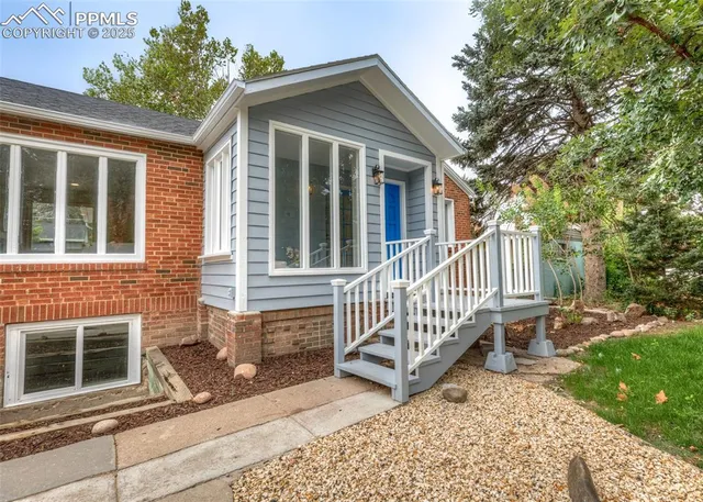 a front view of a house with a garden