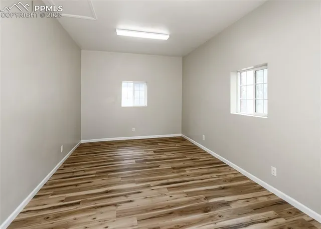 a view of a room with wooden floor and window