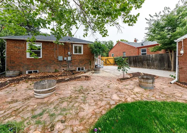 a backyard of a house with table and chairs