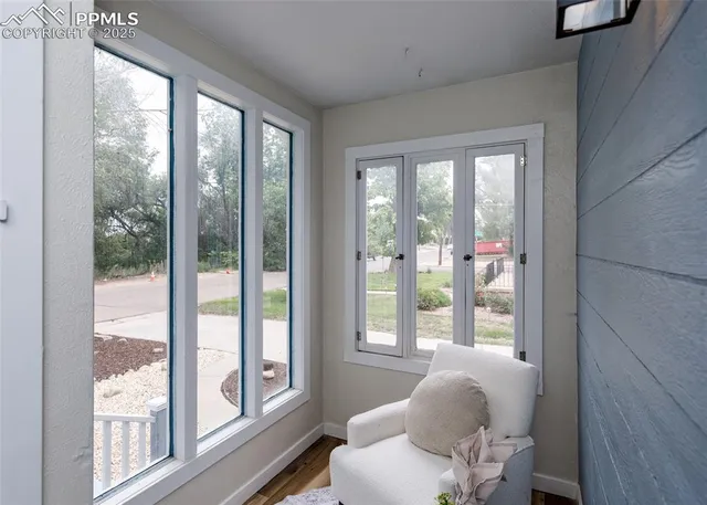 a room with furniture and large windows