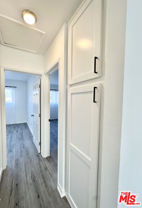 6795 Paramount Boulevard Long Beach, CA 90805 - Photo 5 of 9 a view of a hallway with wooden floor