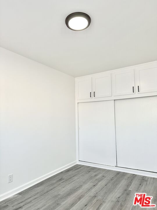 6795 Paramount Boulevard Long Beach, CA 90805 - Photo 6 of 9 an empty room with wooden floor