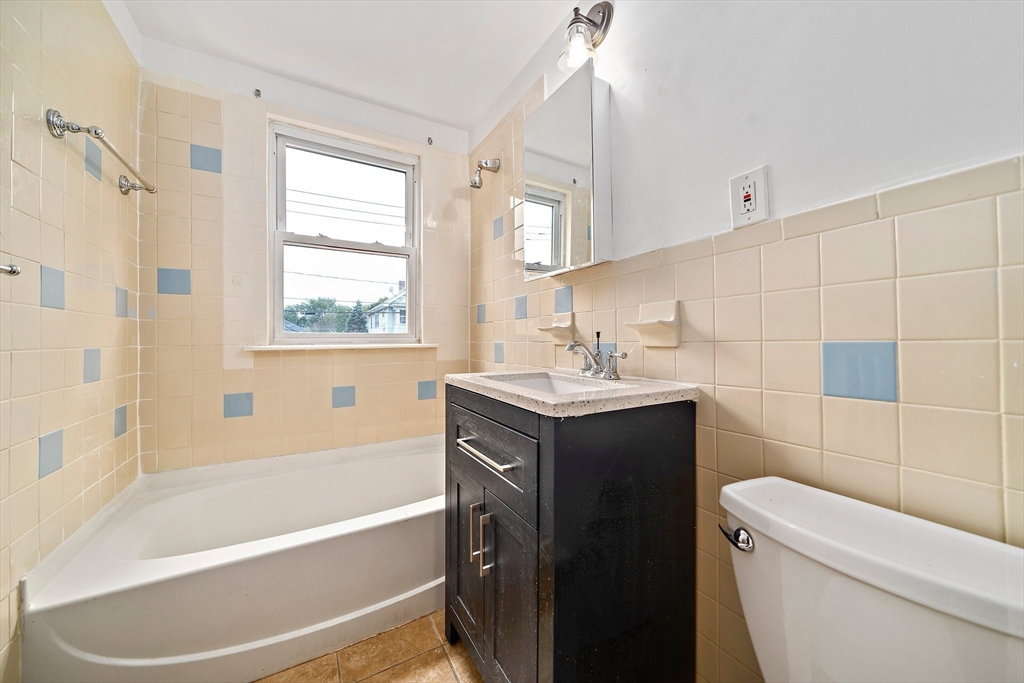 742 River Street, Unit 1 Boston, MA 02136 - Photo 11 of 17 a bathroom with a sink a toilet and shower