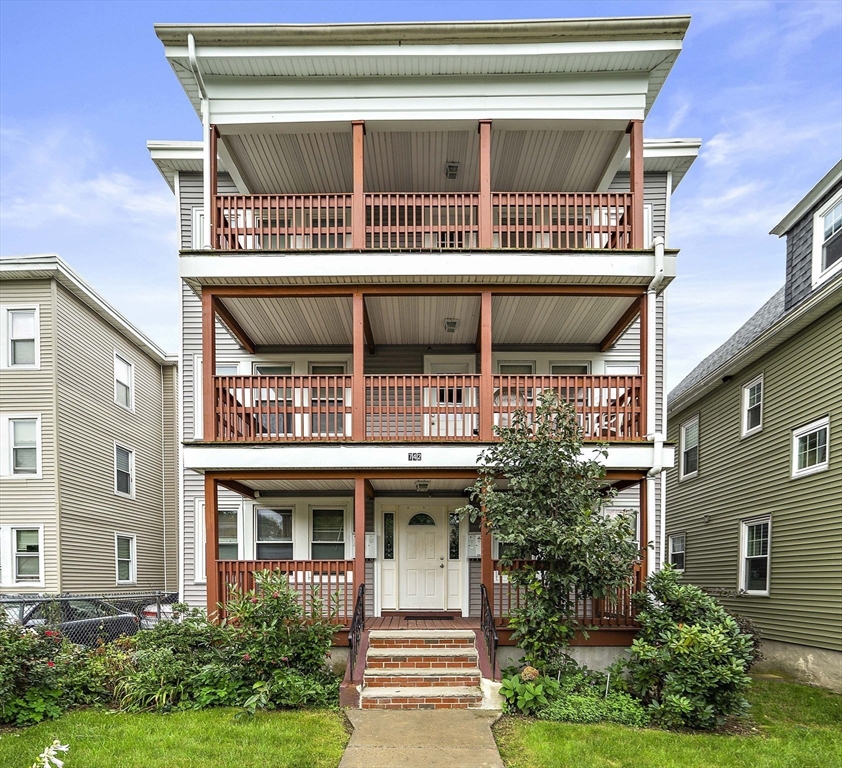 742 River Street, Unit 1 Boston, MA 02136 - Photo 17 of 17 a front view of a house with a garden and plants