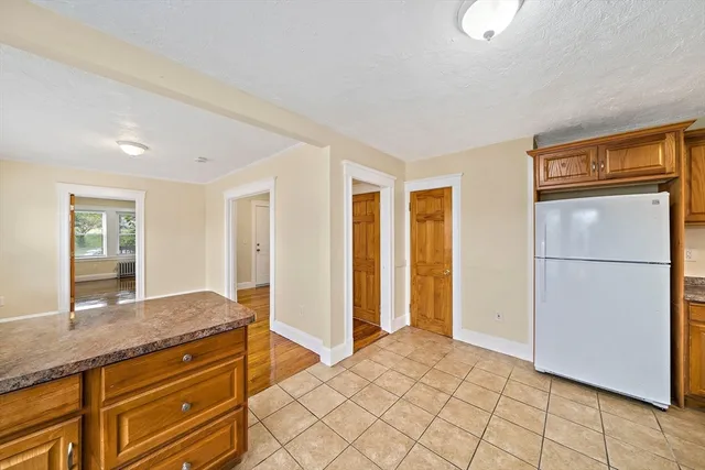 a spacious bathroom with a granite countertop sink and a mirror