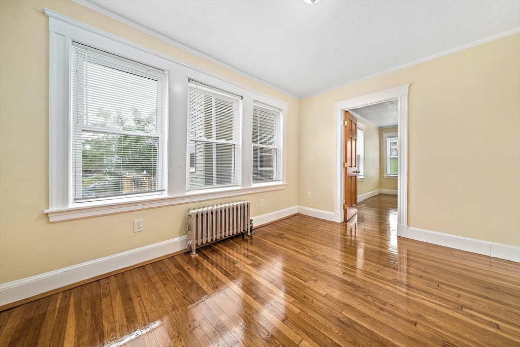 742 River Street, Unit 1 Boston, MA 02136 - Photo 6 of 17 a view of an empty room with wooden floor and a window