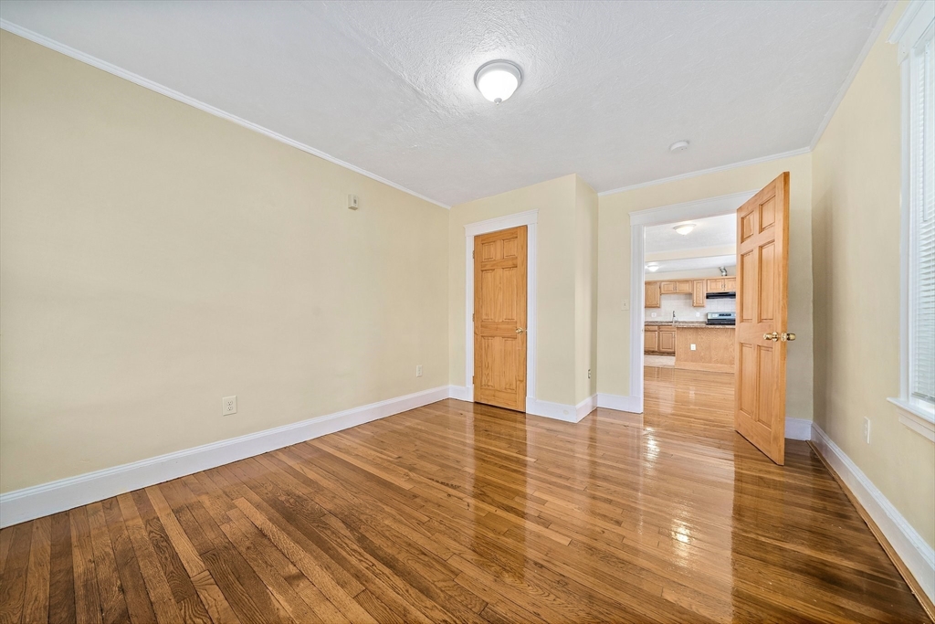 742 River Street, Unit 1 Boston, MA 02136 - Photo 8 of 17 an empty room with wooden floor and windows