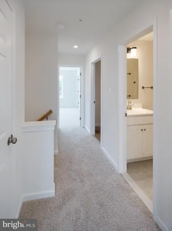 a view of a room with an empty space and a hallway