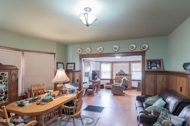 a living room with furniture a chandelier and a table