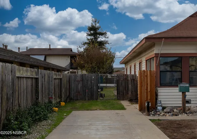 a front view of house with a garden
