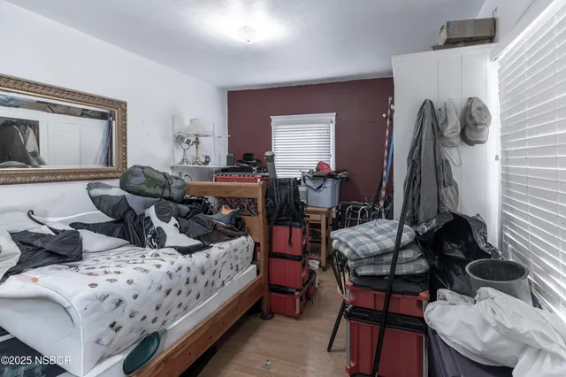 a bedroom with bed and a window