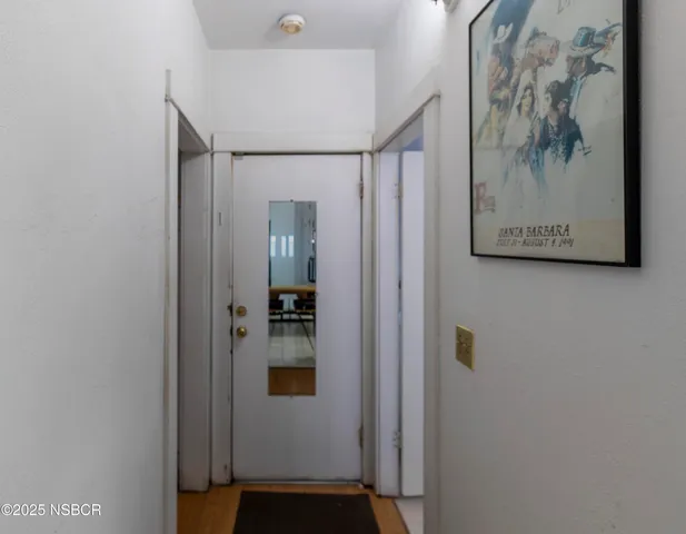 a bathroom with a shower and a painting on the wall