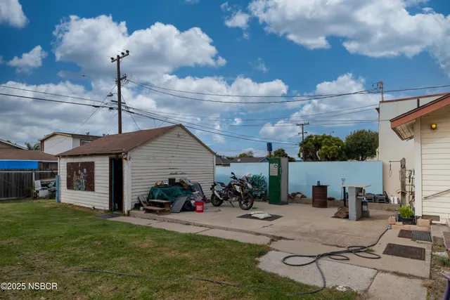 a view of a patio with furniture and a yard