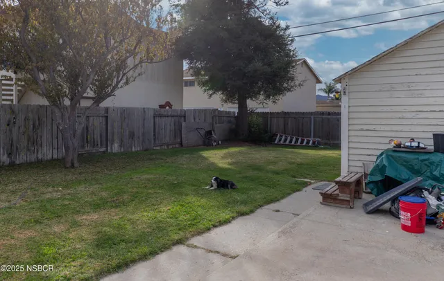 a view of a backyard with a small cabin and a chair