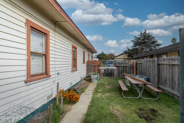 a view of a lounge chair in the backyard of the house