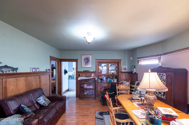 a living room with furniture a lamp and a window