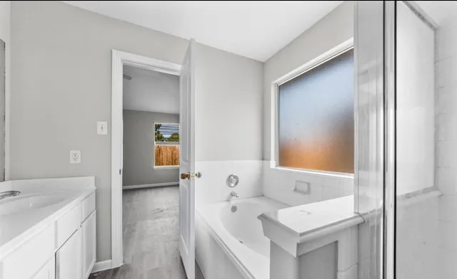 a en suite bathroom with a sink and a mirror