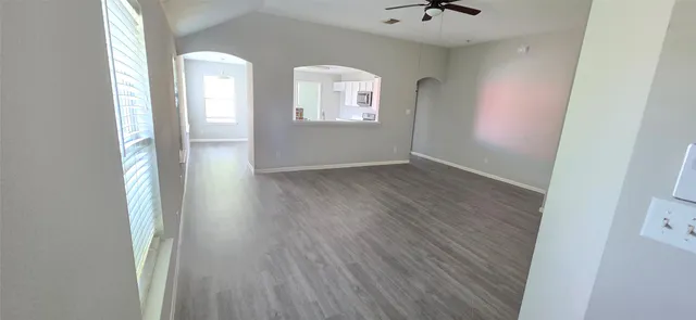an empty room with windows and closet