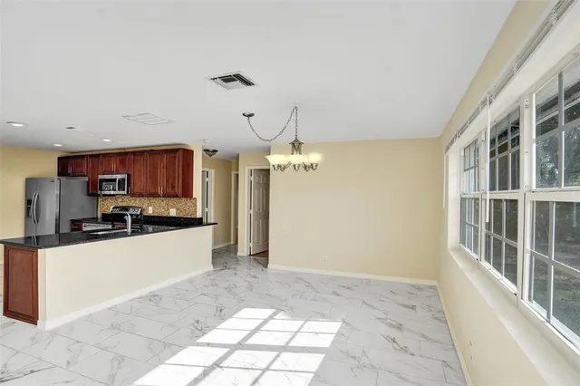 a large kitchen with cabinets and stainless steel appliances
