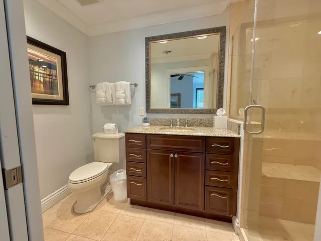 a bathroom with a granite countertop toilet sink and a mirror