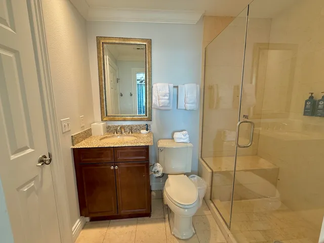 a bathroom with a sink a toilet and shower