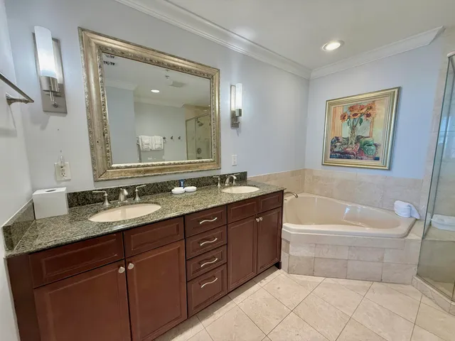 a spacious bathroom with a granite countertop tub sink and mirror