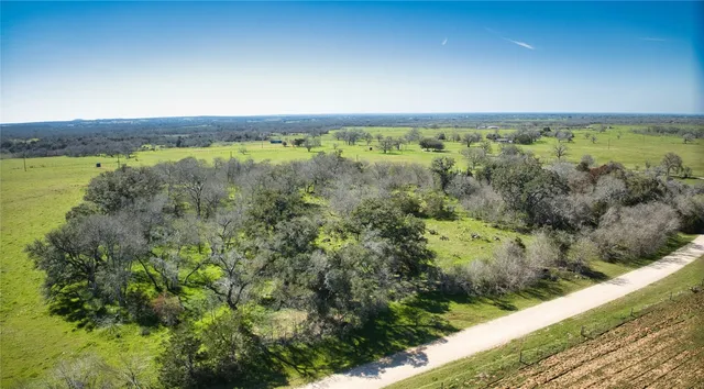 a view of a field with an ocean view
