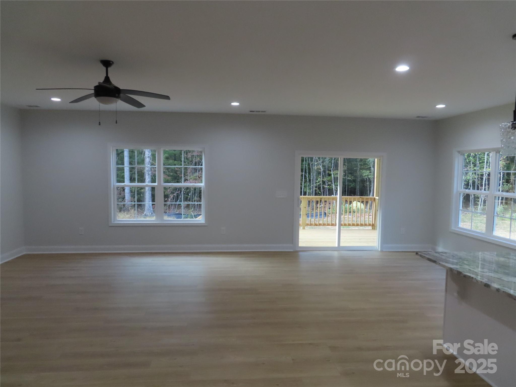 2099 Cedar Road York, SC 29745 - Photo 12 of 37 a view of an empty room with a window and wooden floor