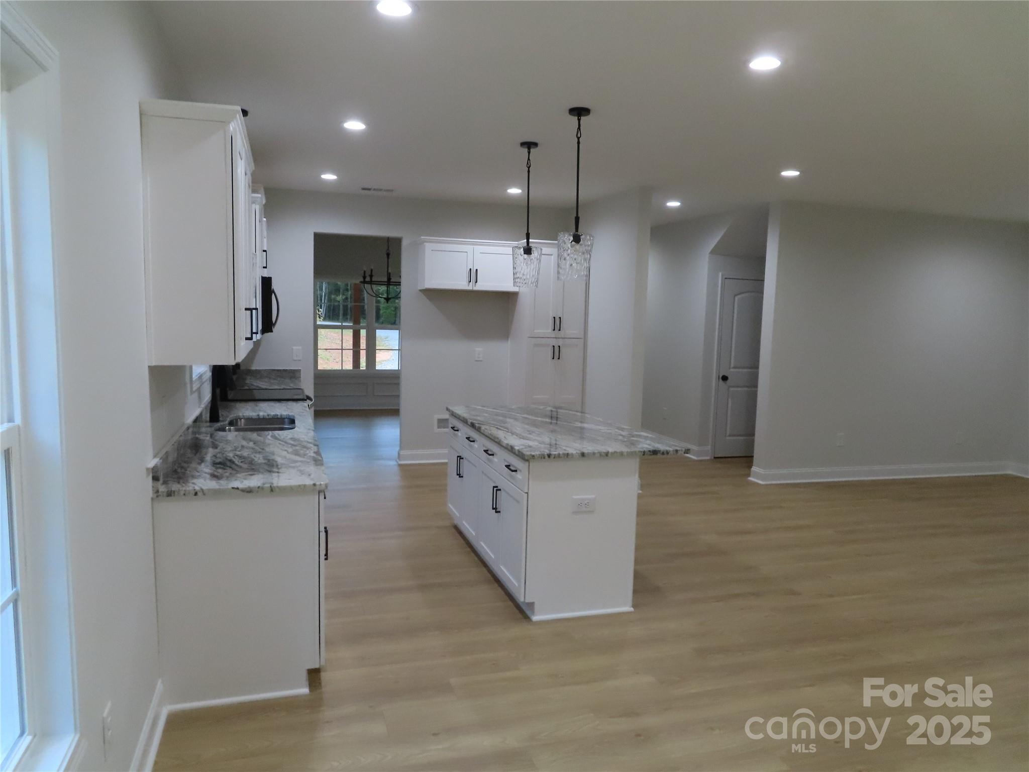 2099 Cedar Road York, SC 29745 - Photo 15 of 37 a large kitchen with stainless steel appliances kitchen island a large counter top a stove a refrigerator and a sink