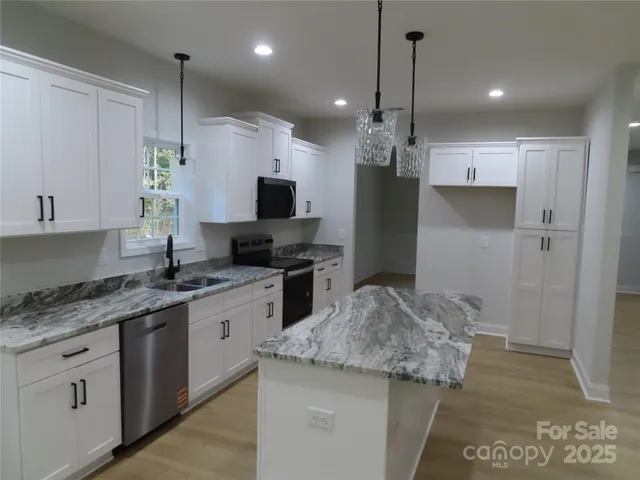 a kitchen with a sink stove and refrigerator