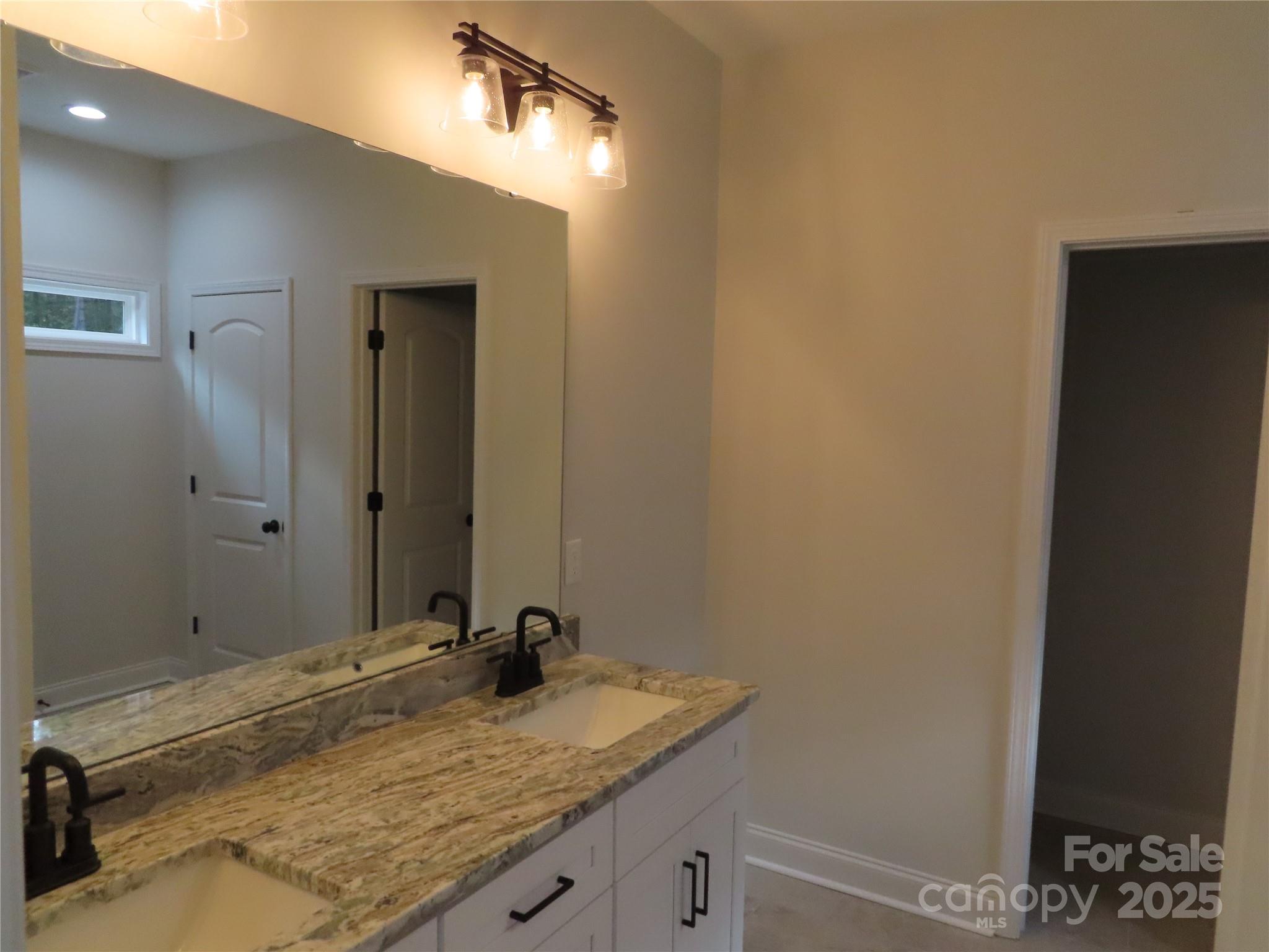 2099 Cedar Road York, SC 29745 - Photo 19 of 37 a bathroom with a granite countertop sink and a mirror