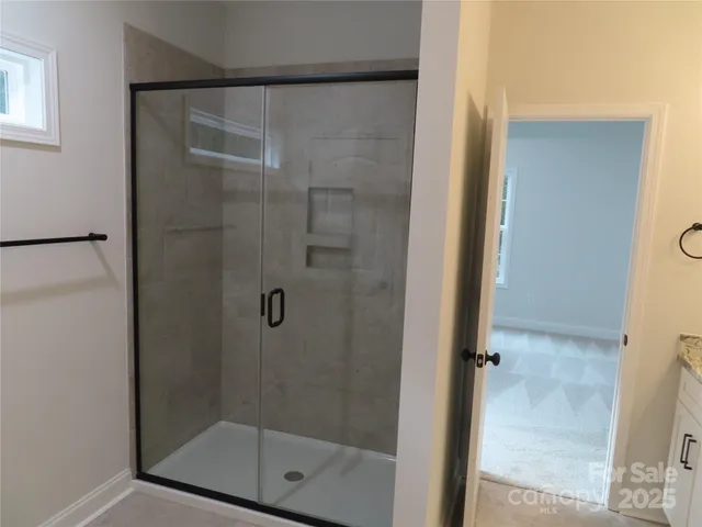 a bathroom with a glass shower door